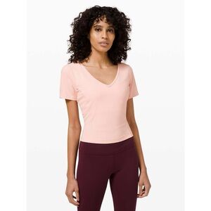 Lululemon “Cropped Slim Yoga” baby pink cropped v-neck tee (measures size 6)